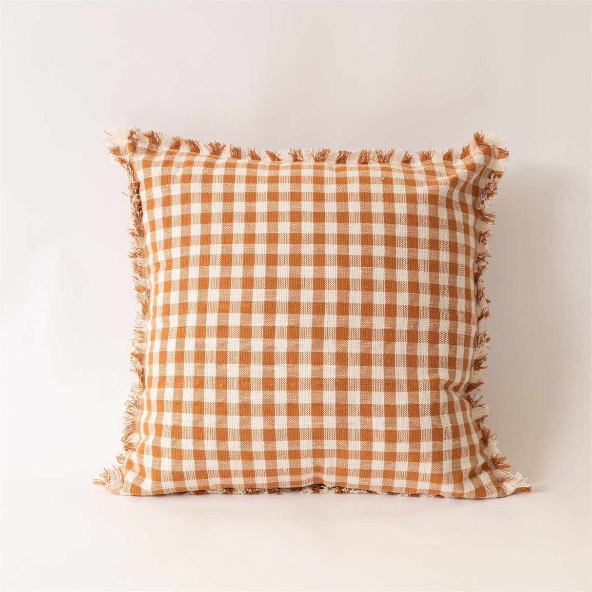 Close-up of rust and cream fall check pillow detail from Magnolias Home Decor
