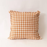 Close-up of rust and cream fall check pillow detail from Magnolias Home Decor