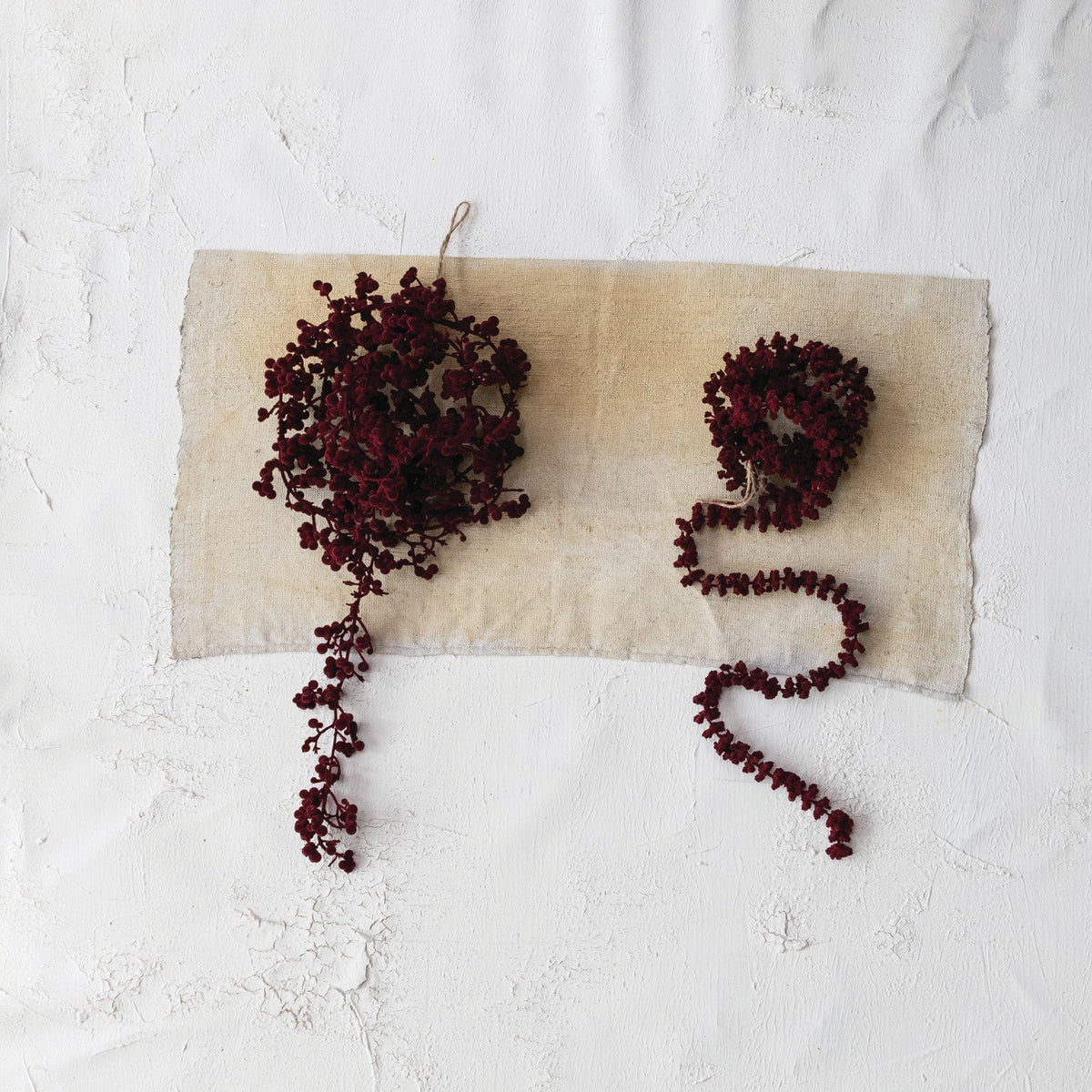Burgundy flocked foam ball garland styled for Christmas home decor from Magnolias Home Decor