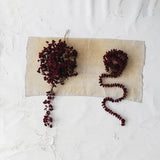 Burgundy flocked foam ball garland styled for Christmas home decor from Magnolias Home Decor